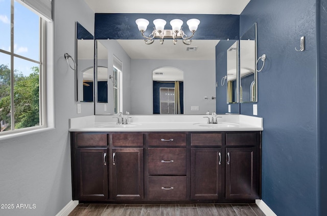 3036 N Acacia Way, Buckeye, AZ 85396 - full bathroom with double vanity, a chandelier, and wood finished floors