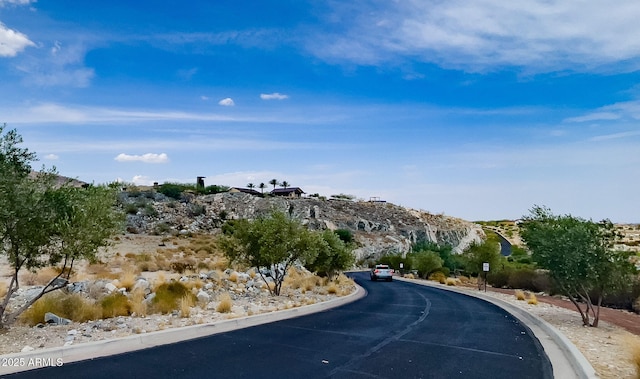 3036 N Acacia Way, Buckeye, AZ 85396 - view of asphalt road featuring curbs