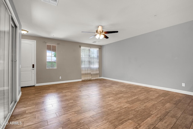 3036 N Acacia Way, Buckeye, AZ 85396 - empty room with a ceiling fan and wood finished floors