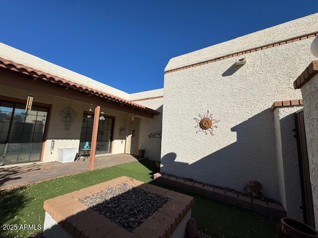 exterior space featuring a fire pit and a patio area