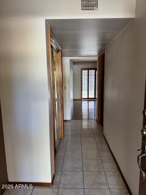 corridor with light tile patterned floors