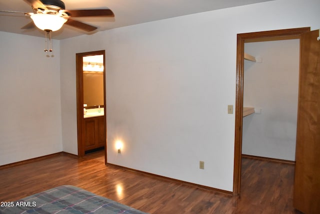 empty room featuring ceiling fan and dark wood-type flooring