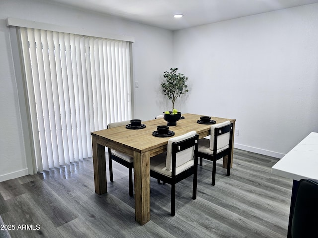 dining room with dark wood-style flooring and baseboards