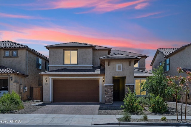 22987 E Pummelos Rd, Queen Creek, AZ 85142 - view of front facade with stone siding, a garage, a tile roof, stucco siding, and driveway