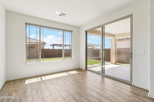 22987 E Pummelos Rd, Queen Creek, AZ 85142 - unfurnished room with wood finished floors, baseboards, and visible vents