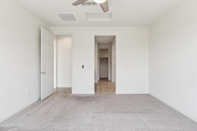 22987 E Pummelos Rd, Queen Creek, AZ 85142 - unfurnished bedroom featuring visible vents, a walk in closet, carpet flooring, and attic access