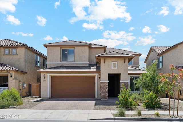 22987 E Pummelos Rd, Queen Creek, AZ 85142 - view of front of house with stucco siding, driveway, stone siding, an attached garage, and a tiled roof