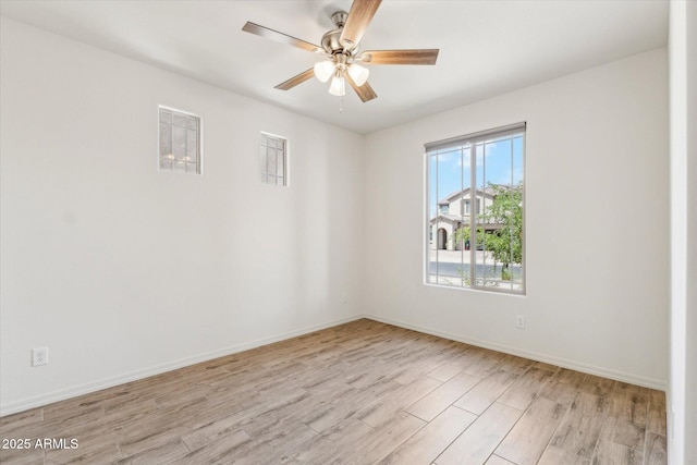 22987 E Pummelos Rd, Queen Creek, AZ 85142 - empty room with baseboards, light wood finished floors, and a ceiling fan
