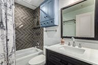 706 E Washington St Unit 207, Phoenix, AZ 85034 - bathroom with toilet, shower / bath combo with shower curtain, vanity, and brick patterned flooring