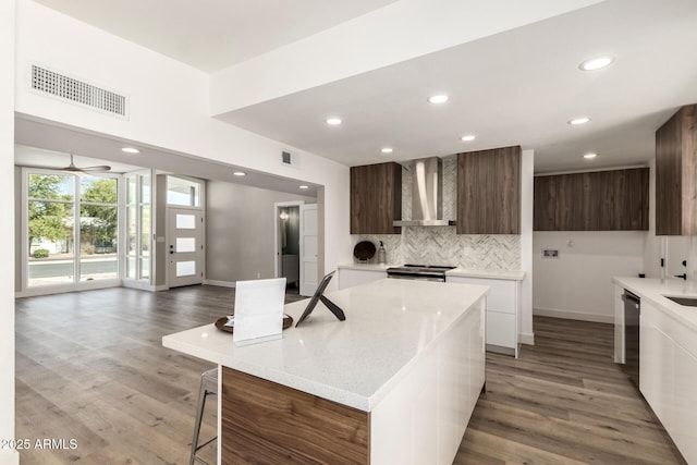 1920 N Cavalier Dr, Tempe, AZ 85288 - kitchen featuring modern cabinets, wall chimney exhaust hood, appliances with stainless steel finishes, backsplash, and recessed lighting