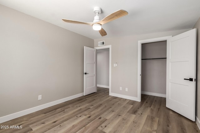1920 N Cavalier Dr, Tempe, AZ 85288 - unfurnished bedroom with baseboards, wood finished floors, a closet, and a ceiling fan