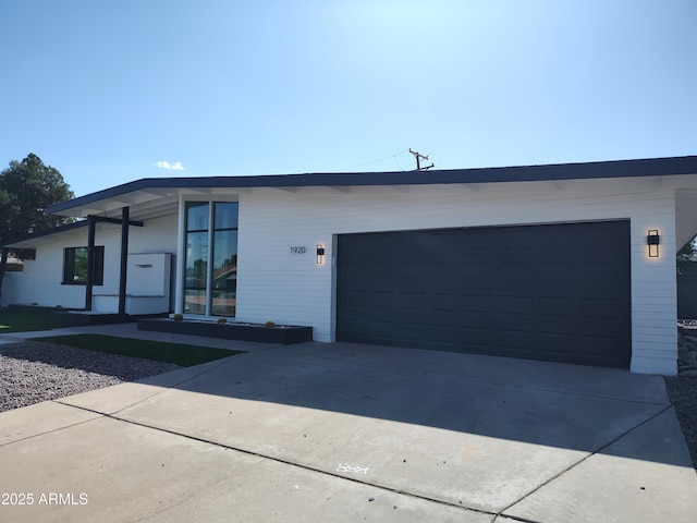 1920 N Cavalier Dr, Tempe, AZ 85288 - contemporary house featuring an attached garage and driveway