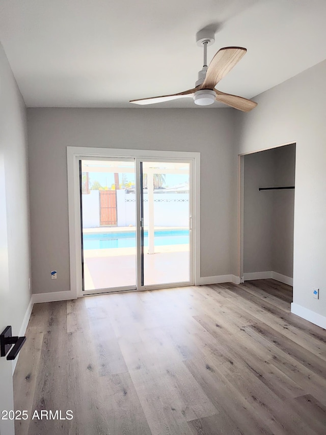 1920 N Cavalier Dr, Tempe, AZ 85288 - unfurnished bedroom with access to exterior, wood finished floors, baseboards, and ceiling fan