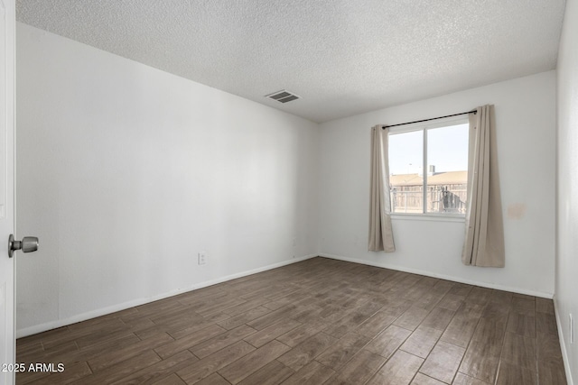 empty room with a textured ceiling