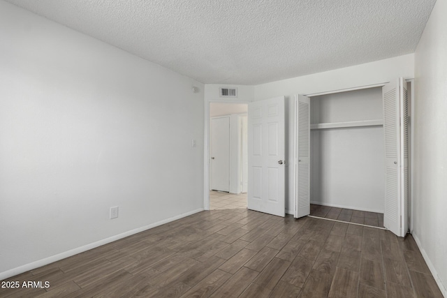 unfurnished bedroom featuring a closet and a textured ceiling