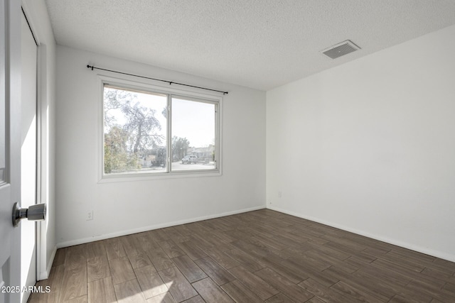 unfurnished room with a textured ceiling