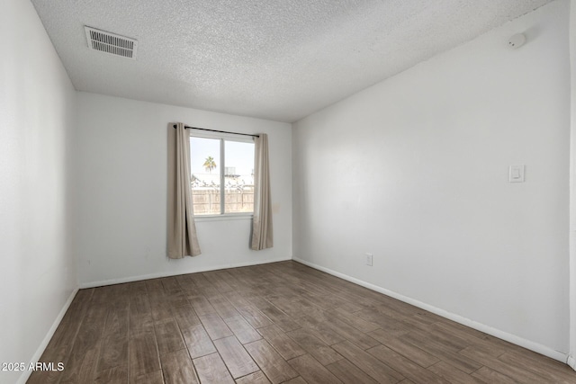 spare room with a textured ceiling