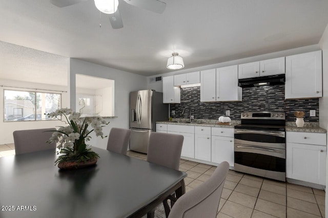 kitchen with stainless steel appliances, white cabinets, and light tile patterned flooring