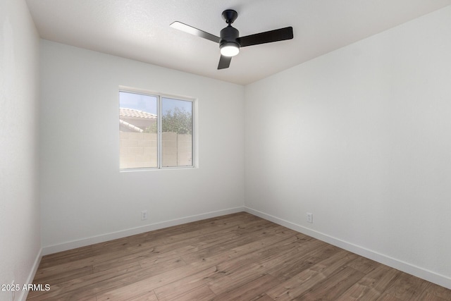 unfurnished room with light wood-style floors, ceiling fan, and baseboards