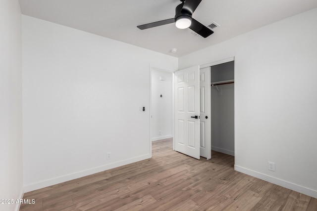 unfurnished bedroom featuring a closet, light wood-type flooring, baseboards, visible vents, and ceiling fan