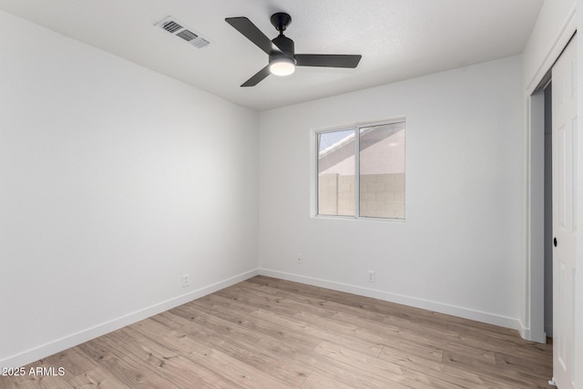 unfurnished bedroom featuring visible vents, light wood-style flooring, a closet, and baseboards