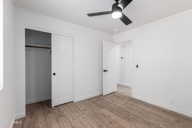 unfurnished bedroom featuring a closet, baseboards, light wood-type flooring, and ceiling fan