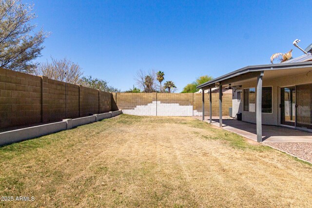 view of yard with a fenced backyard and a patio area
