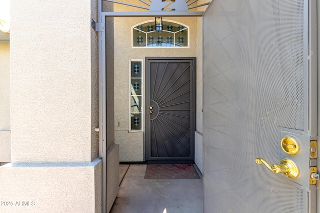 property entrance featuring stucco siding
