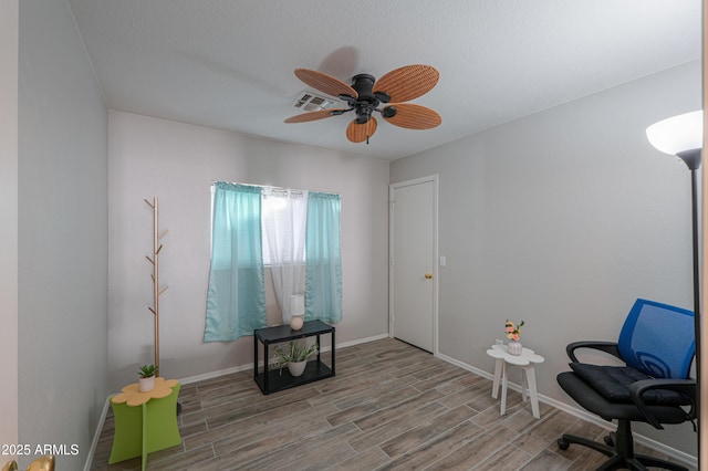 living area featuring ceiling fan and wood-type flooring