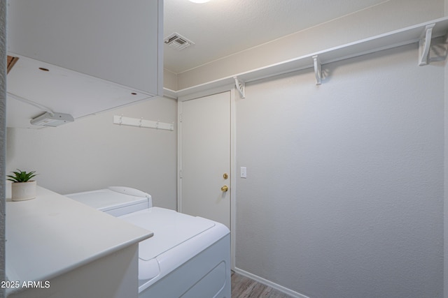 laundry area featuring hardwood / wood-style floors and washing machine and clothes dryer