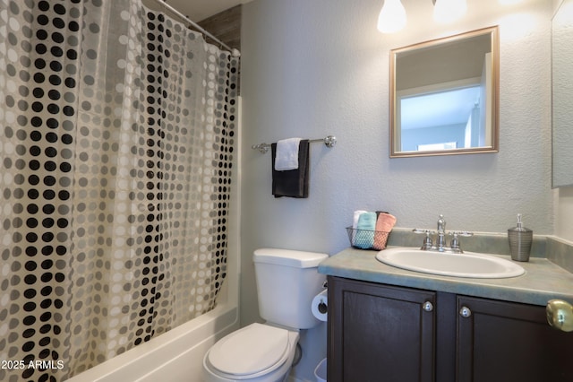 full bathroom with vanity, shower / tub combo, and toilet