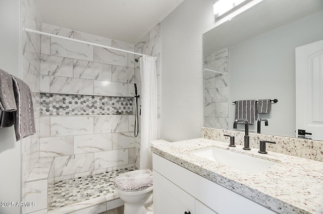 bathroom with vanity, curtained shower, and toilet