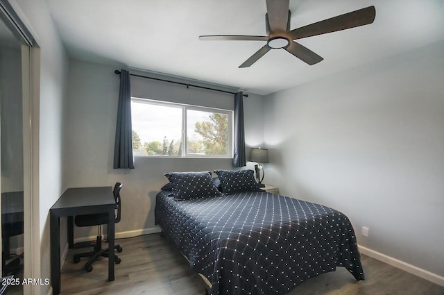 bedroom featuring dark wood-type flooring and ceiling fan