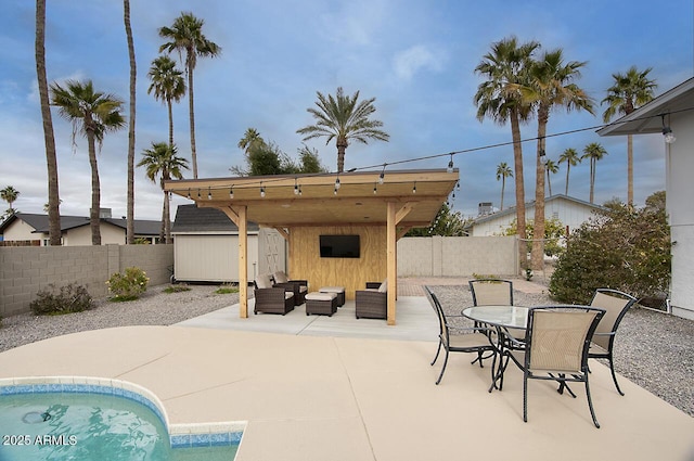 view of patio / terrace featuring an outdoor living space and a shed