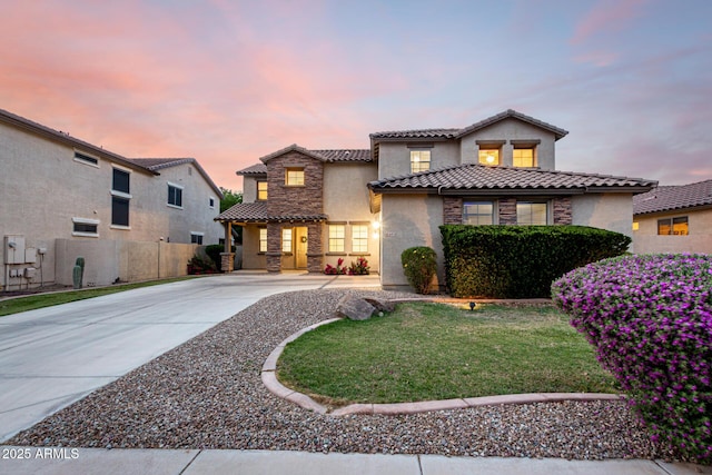 21472 E Saddle Ct, Queen Creek, AZ 85142 - mediterranean / spanish-style home featuring a tiled roof, stucco siding, driveway, and stone siding