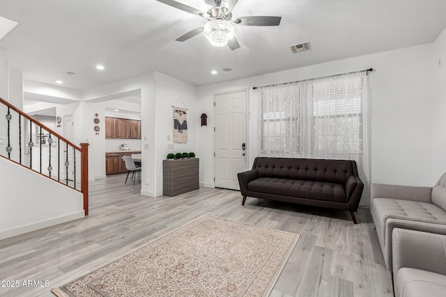 21472 E Saddle Ct, Queen Creek, AZ 85142 - living area featuring stairs, light wood-type flooring, ceiling fan, recessed lighting, and baseboards