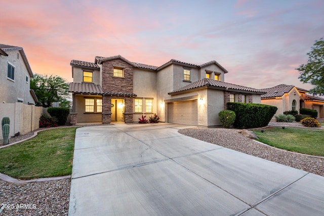 21472 E Saddle Ct, Queen Creek, AZ 85142 - mediterranean / spanish house with stucco siding, a tiled roof, driveway, stone siding, and a garage