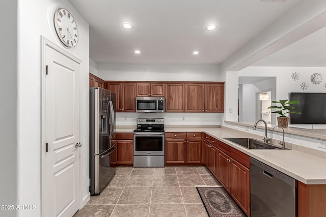 21472 E Saddle Ct, Queen Creek, AZ 85142 - kitchen featuring stainless steel appliances, a sink, light countertops, recessed lighting, and brown cabinetry