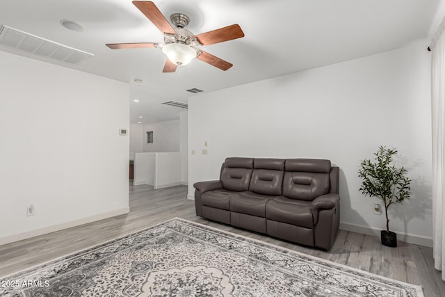 21472 E Saddle Ct, Queen Creek, AZ 85142 - living room featuring wood finished floors, ceiling fan, and baseboards