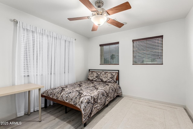 21472 E Saddle Ct, Queen Creek, AZ 85142 - bedroom with baseboards, wood finished floors, and a ceiling fan