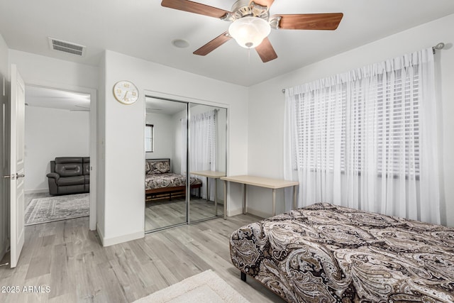 21472 E Saddle Ct, Queen Creek, AZ 85142 - bedroom featuring light wood-style floors, a closet, baseboards, and a ceiling fan