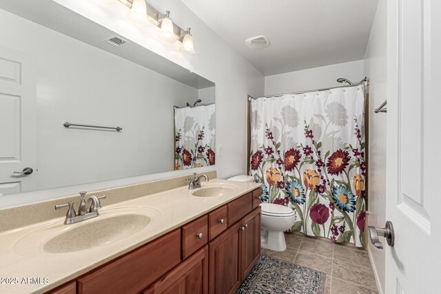 21472 E Saddle Ct, Queen Creek, AZ 85142 - bathroom with double vanity, toilet, tile patterned floors, and curtained shower
