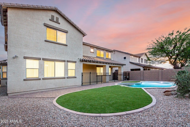 21472 E Saddle Ct, Queen Creek, AZ 85142 - back of house featuring a fenced backyard, stucco siding, a tile roof, and a patio
