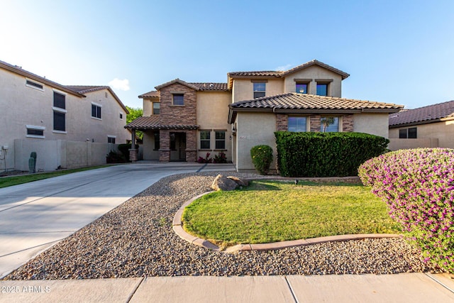 21472 E Saddle Ct, Queen Creek, AZ 85142 - mediterranean / spanish-style house with a tile roof, stucco siding, concrete driveway, and stone siding