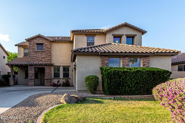 21472 E Saddle Ct, Queen Creek, AZ 85142 - mediterranean / spanish-style home with stucco siding, a tile roof, a front lawn, and stone siding