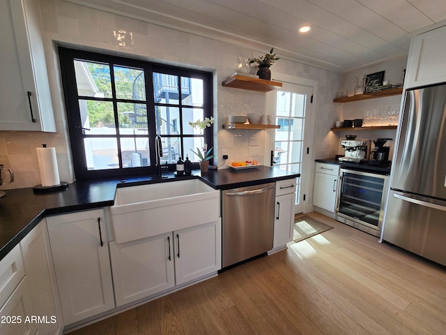 kitchen featuring appliances with stainless steel finishes, white cabinetry, and open shelves