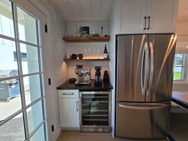 bar featuring a bar, wine cooler, tile walls, and freestanding refrigerator