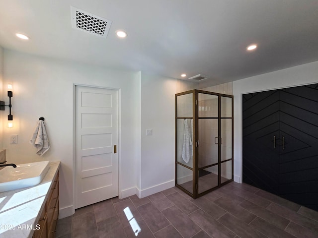 bathroom with a stall shower, visible vents, vanity, and recessed lighting