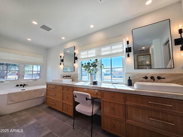 bathroom with recessed lighting, vanity, visible vents, and a healthy amount of sunlight