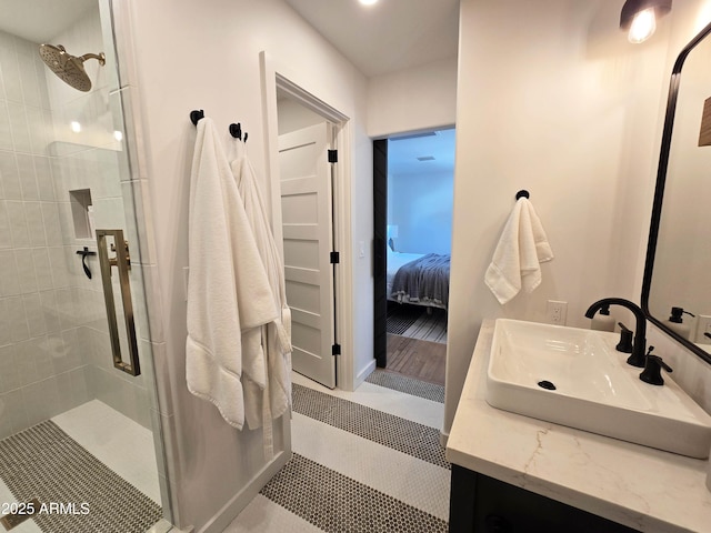 bathroom with ensuite bathroom, a shower stall, and vanity